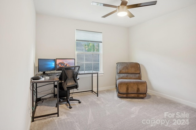 office area featuring light carpet and ceiling fan