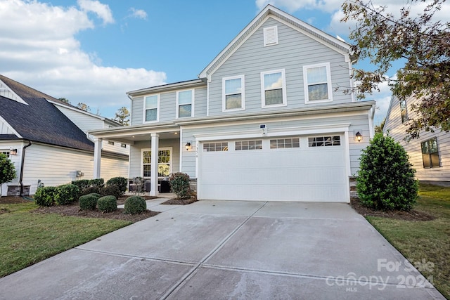 view of front property with a front lawn and a garage