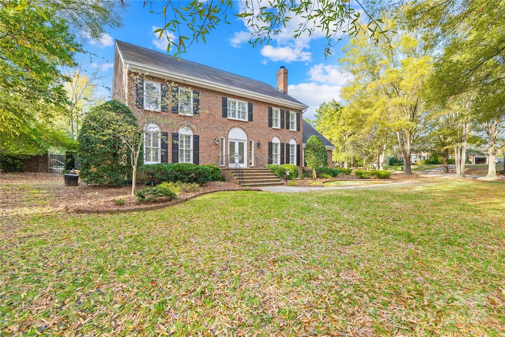 colonial-style house with a front yard