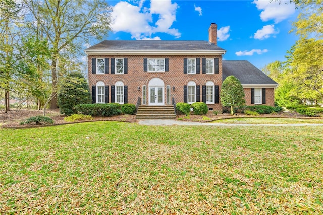 colonial home with french doors and a front lawn