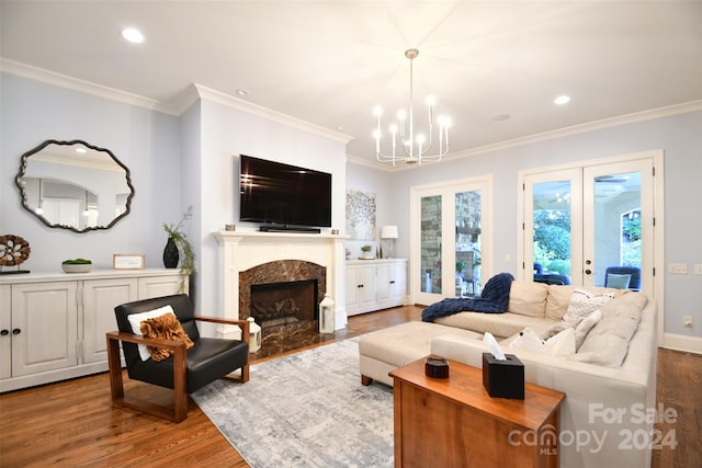 living room featuring a fireplace, french doors, hardwood / wood-style flooring, and ornamental molding