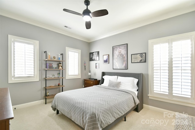 carpeted bedroom with ceiling fan and ornamental molding