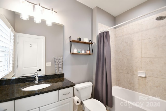 full bathroom featuring shower / bath combo, vanity, and toilet