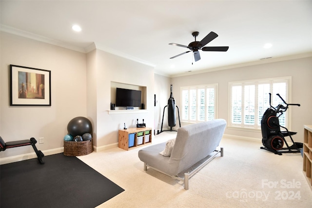 workout room with light carpet, ceiling fan, and crown molding