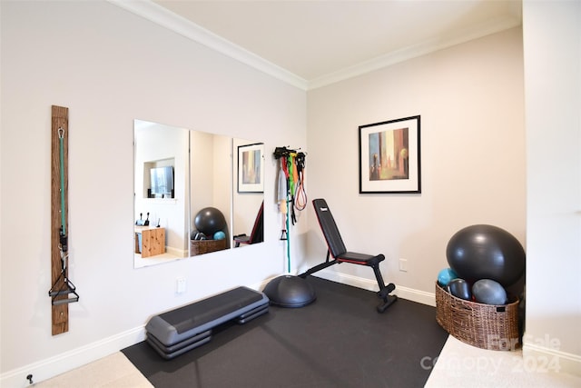 workout room featuring crown molding