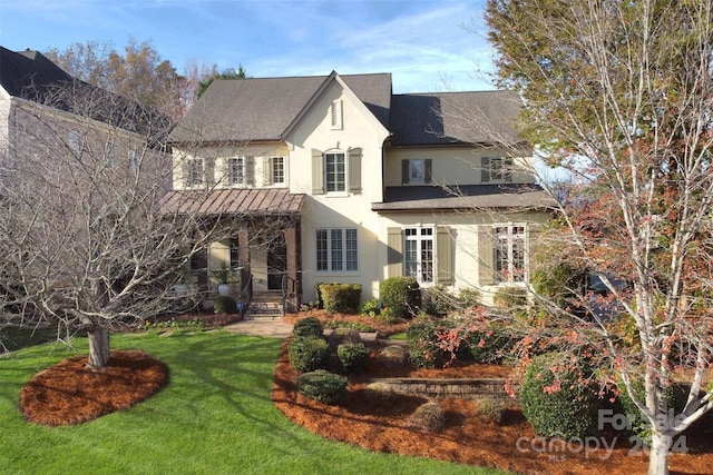 rear view of house featuring a lawn