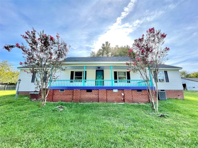 view of front of property with a front yard and central AC unit