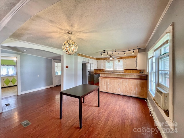 kitchen featuring dark wood-type flooring, wood counters, stainless steel fridge, a textured ceiling, and ornamental molding