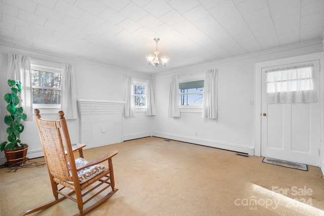 sitting room featuring carpet floors, ornamental molding, a baseboard heating unit, and an inviting chandelier