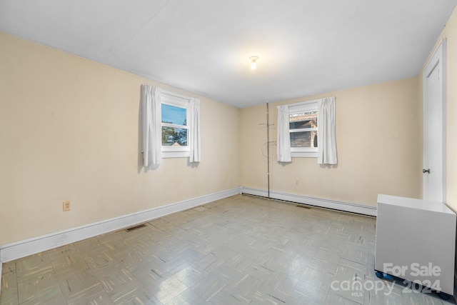 unfurnished room featuring a baseboard radiator