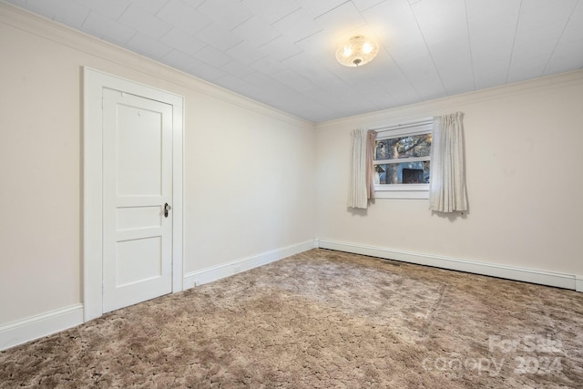 carpeted spare room featuring crown molding and a baseboard radiator