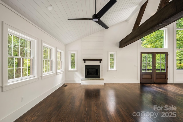 unfurnished living room featuring plenty of natural light, a fireplace, and dark wood-type flooring