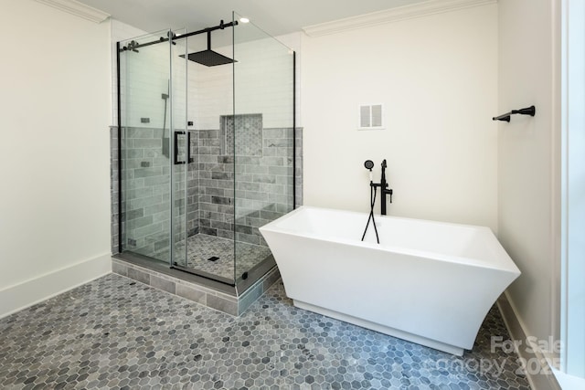 full bath with visible vents, baseboards, ornamental molding, a stall shower, and a freestanding tub