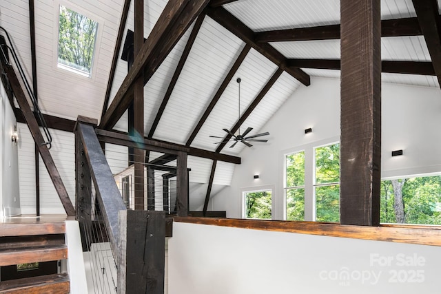 stairs featuring beamed ceiling and high vaulted ceiling