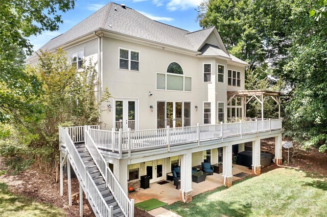 back of property featuring french doors, a yard, a deck, and a patio