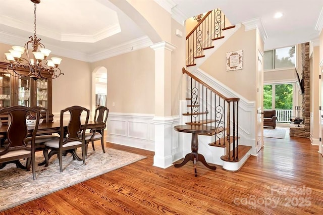 interior space with ornate columns, ornamental molding, and hardwood / wood-style floors