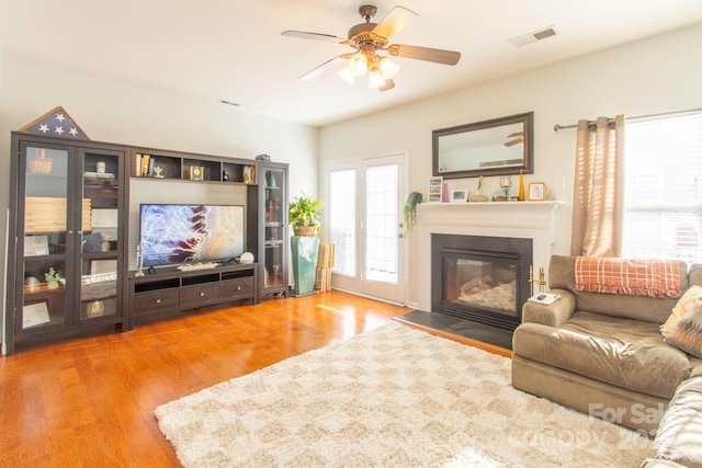 living room featuring ceiling fan and hardwood / wood-style flooring