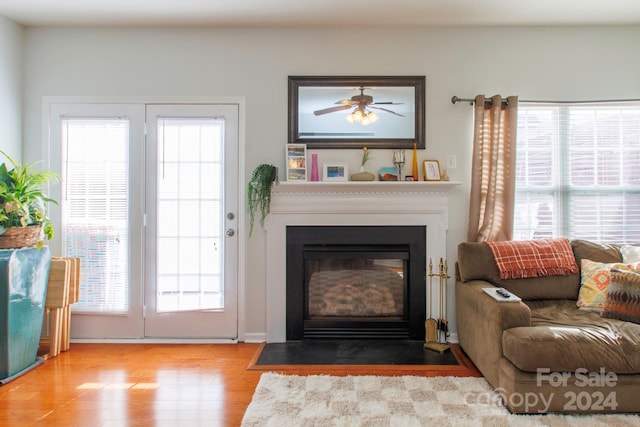 living room featuring light hardwood / wood-style floors, a wealth of natural light, and ceiling fan