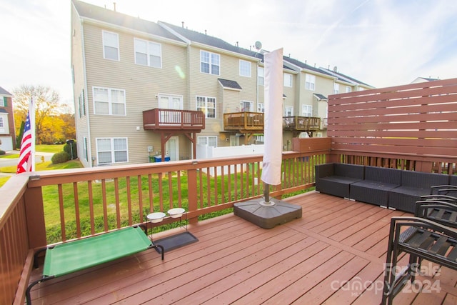 wooden terrace featuring outdoor lounge area and a yard