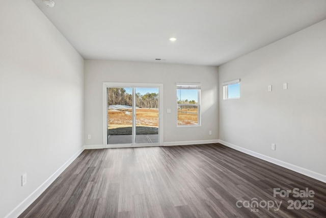 unfurnished room featuring dark wood-type flooring