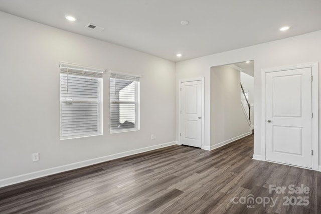 spare room featuring dark hardwood / wood-style flooring