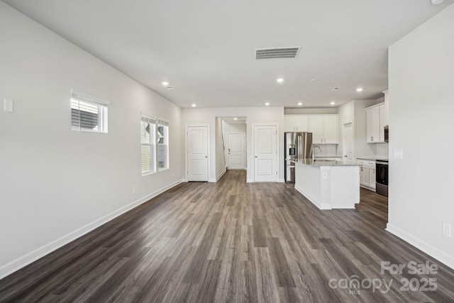 unfurnished living room with dark hardwood / wood-style flooring and sink