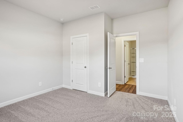 unfurnished bedroom featuring dark colored carpet