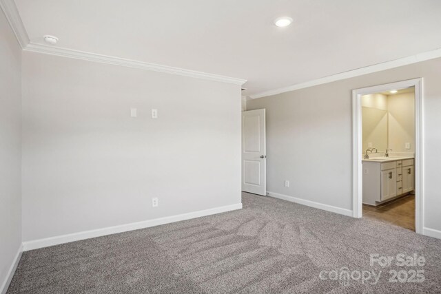 carpeted spare room featuring crown molding