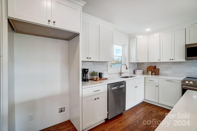 kitchen featuring dark wood-type flooring, white cabinetry, sink, and stainless steel appliances