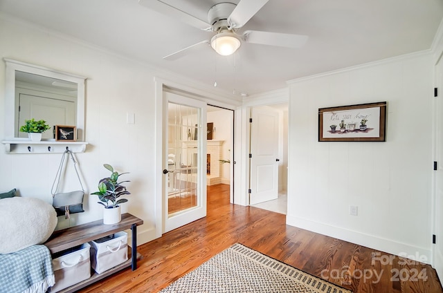 sitting room featuring hardwood / wood-style flooring, ceiling fan, crown molding, and french doors