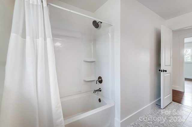 bathroom with tile patterned flooring and shower / tub combo with curtain