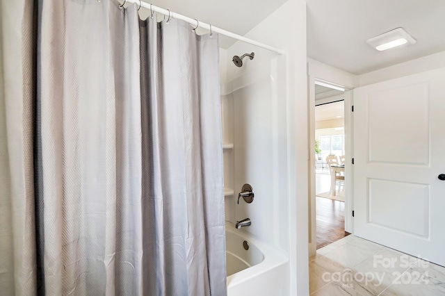 bathroom with tile patterned flooring and shower / bathtub combination with curtain