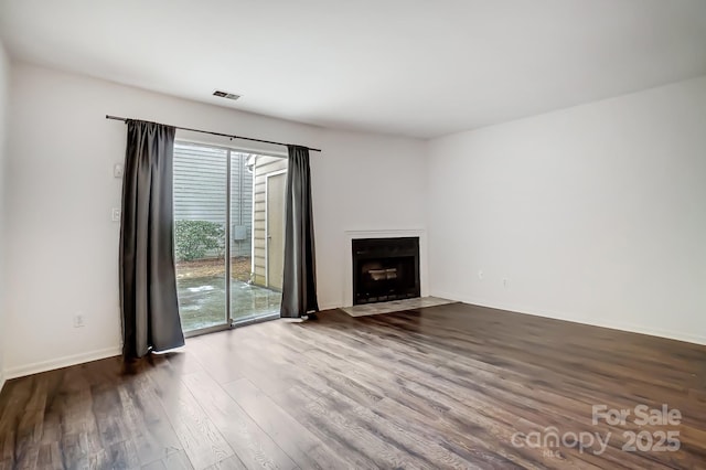 unfurnished living room featuring dark hardwood / wood-style floors