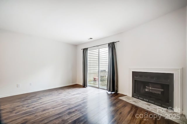 unfurnished living room featuring dark hardwood / wood-style flooring