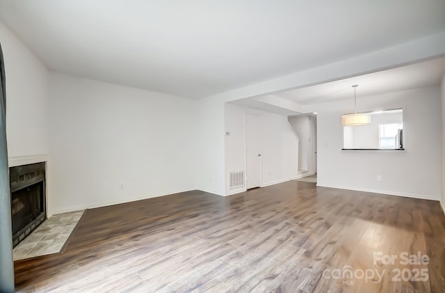 unfurnished living room with hardwood / wood-style floors