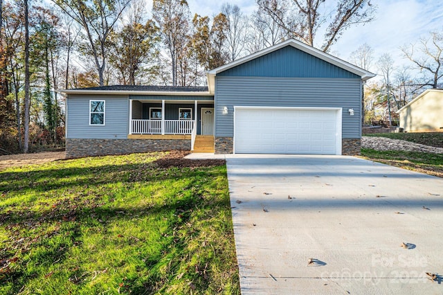 ranch-style house featuring a front yard, a porch, and a garage