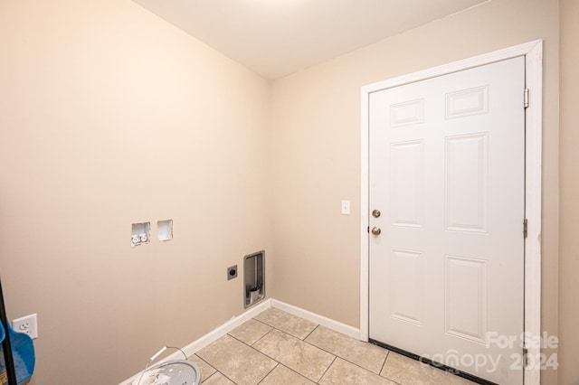 clothes washing area with hookup for an electric dryer, washer hookup, and light tile patterned floors