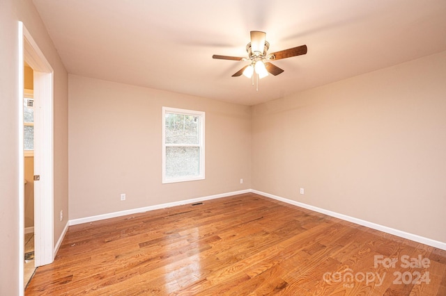 spare room with light wood-type flooring and ceiling fan