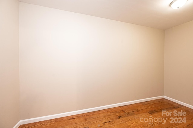 empty room with hardwood / wood-style floors