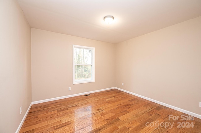 spare room with light hardwood / wood-style floors