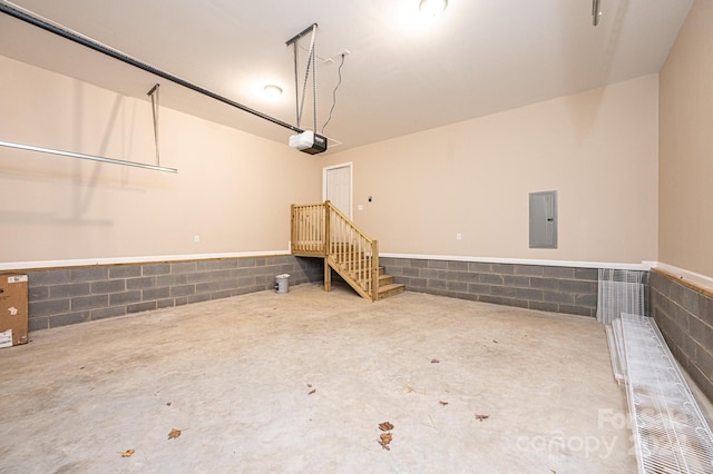 garage with electric panel and a garage door opener