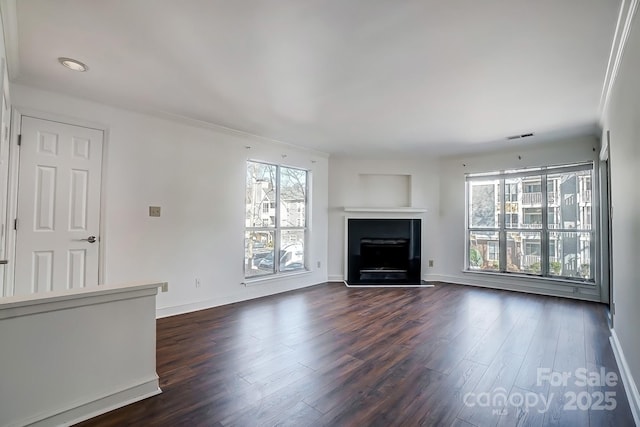 unfurnished living room featuring visible vents, a fireplace, baseboards, and dark wood-type flooring