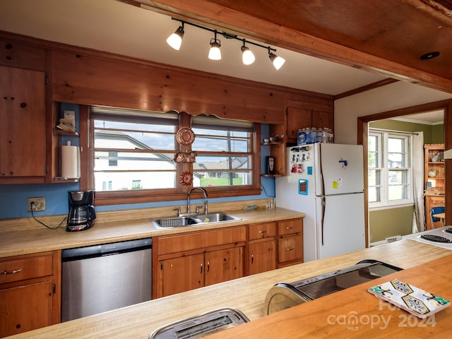 kitchen with dishwasher, white refrigerator, a healthy amount of sunlight, and sink