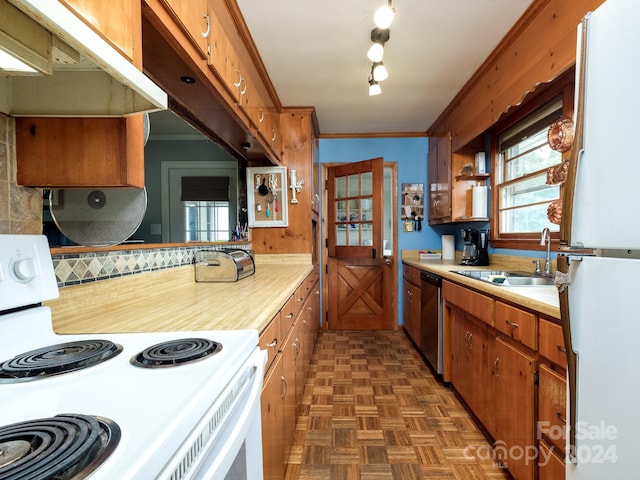 kitchen with dark parquet flooring, white appliances, crown molding, sink, and tasteful backsplash