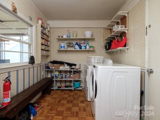 laundry area with dark parquet flooring and washer and clothes dryer