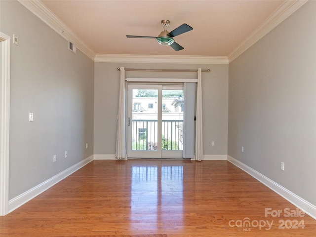 empty room featuring ceiling fan, wood-type flooring, and crown molding