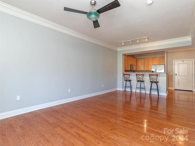 unfurnished living room featuring ceiling fan, light hardwood / wood-style floors, crown molding, and track lighting