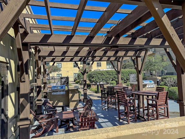 view of patio / terrace featuring exterior kitchen and a pergola