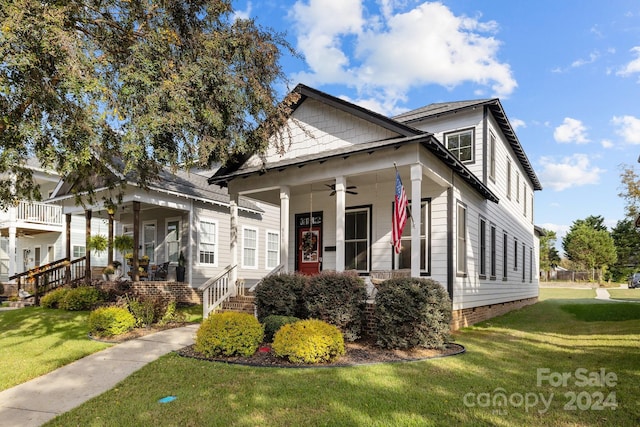 bungalow-style house with ceiling fan, a front lawn, and a porch