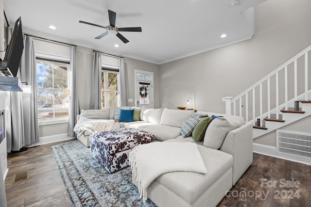 living room featuring ceiling fan, dark hardwood / wood-style flooring, and ornamental molding